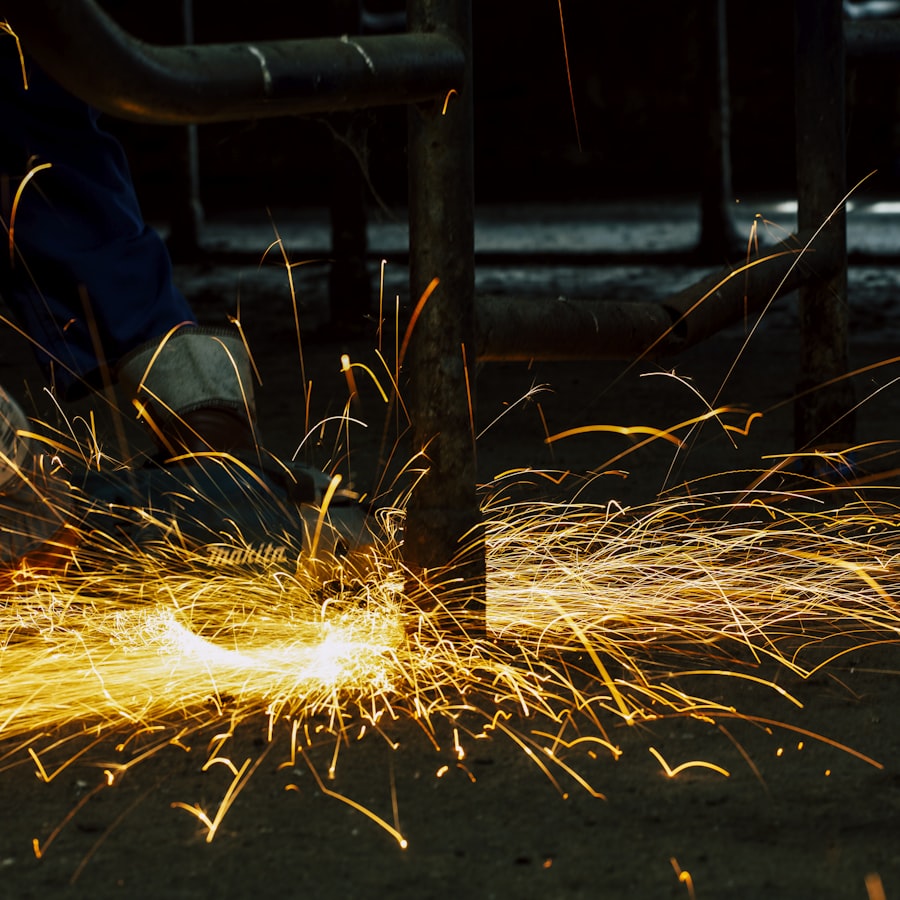 Two welders working on a piece of metal with bright sparks