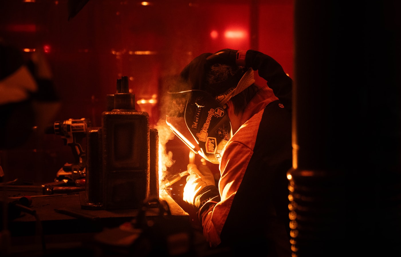 Welder running a structural weld in a factory setting
